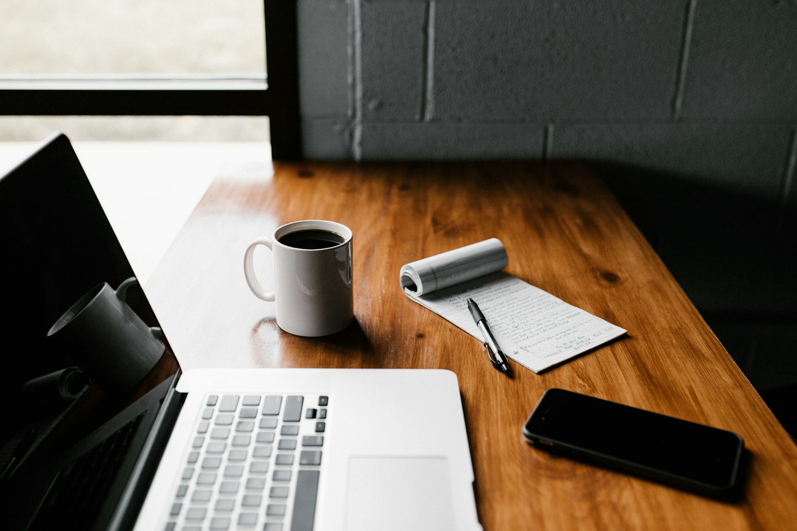 A writer’s desk with notebook and coffee